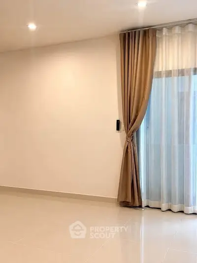Spacious empty room with elegant curtains and glossy tiled floor, perfect for customization.