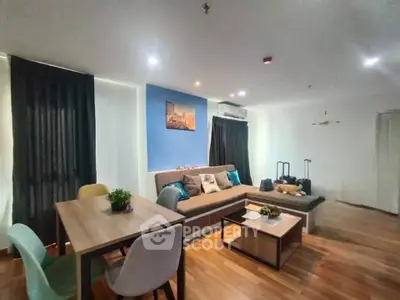Modern living room with stylish furniture and wooden flooring in a cozy apartment.