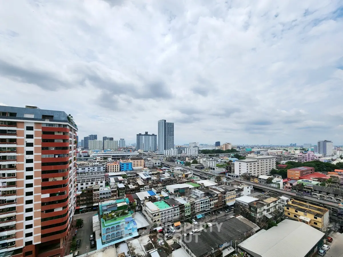 Stunning cityscape view from high-rise building showcasing urban skyline and architectural diversity.