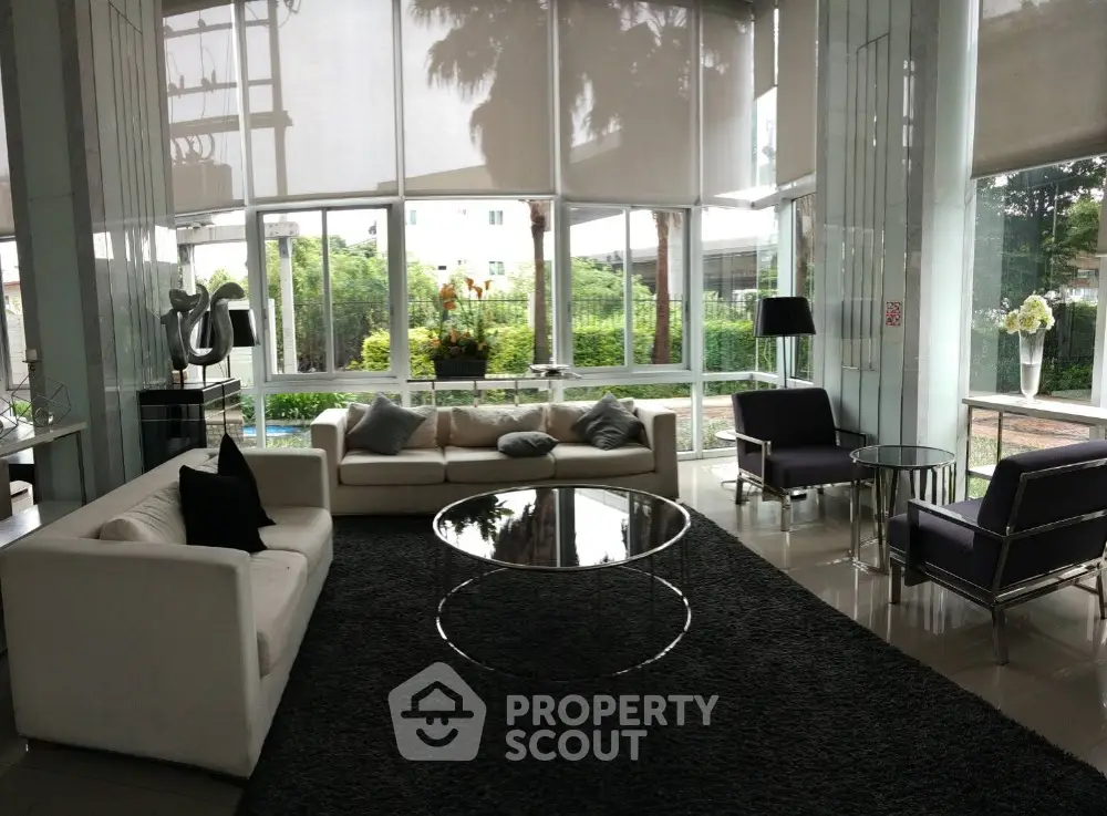 Luxurious modern living room with large windows and elegant furniture