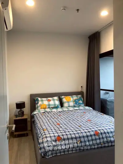 Cozy bedroom with stylish decor and ample natural light, perfect for relaxation and comfort.