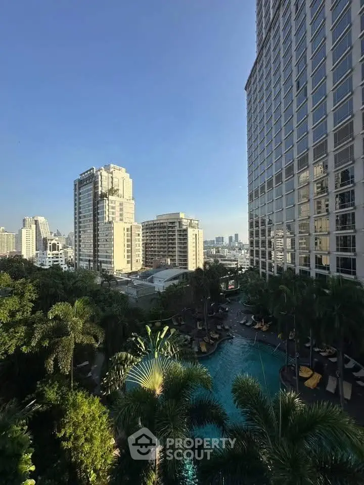 Luxurious high-rise buildings with a stunning pool view and lush greenery in an urban setting.