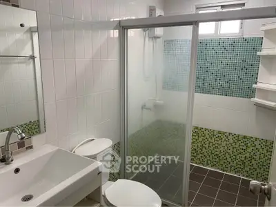 Modern bathroom with glass shower and stylish tile accents