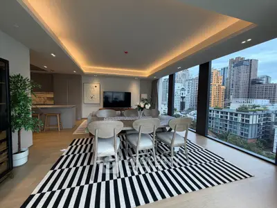 Luxurious open-plan living room with stunning city views and modern decor