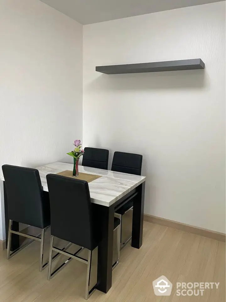 Modern dining area with sleek black chairs and minimalist decor