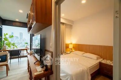 Modern apartment with cozy bedroom and stunning city view from the balcony, perfect for urban living.