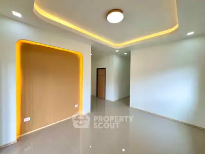 Modern living room with recessed lighting and sleek tile flooring