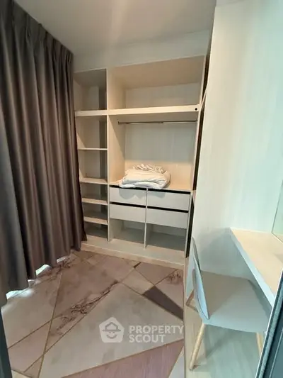 Spacious walk-in closet with modern shelving and elegant curtains