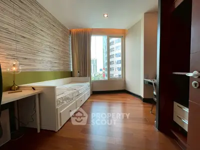 Modern bedroom with city view, wooden flooring, and stylish decor