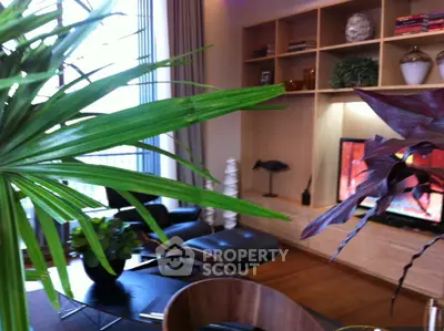 Stylish living room with modern decor, large windows, and elegant shelving unit.