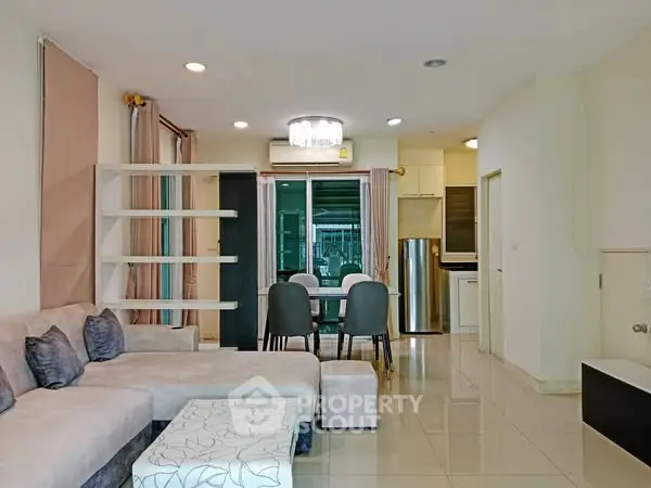 Spacious modern living room with elegant decor and open kitchen layout