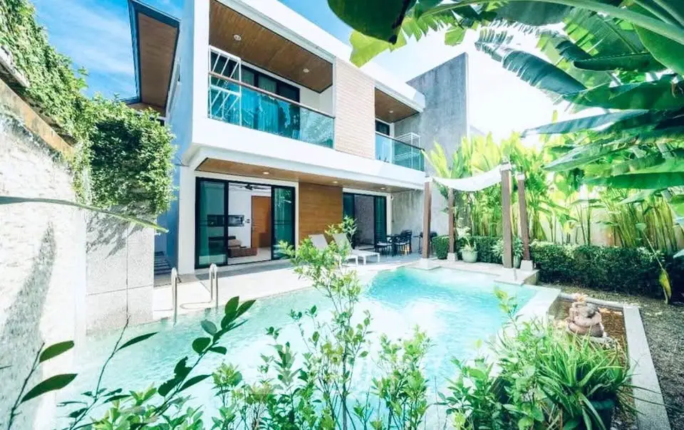 Luxurious modern villa with private pool and lush garden, perfect for tropical living.