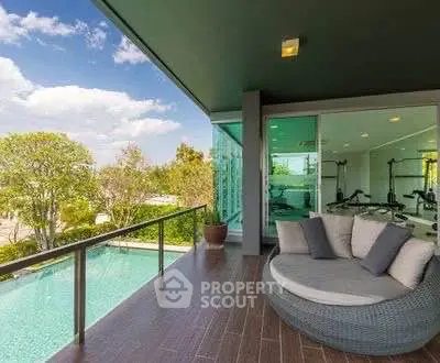 Luxurious balcony with pool view and modern outdoor seating