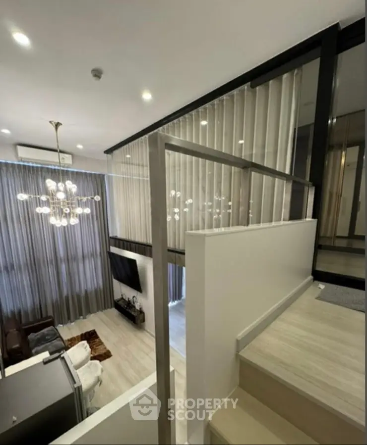 Modern duplex living room with high ceilings and elegant chandelier
