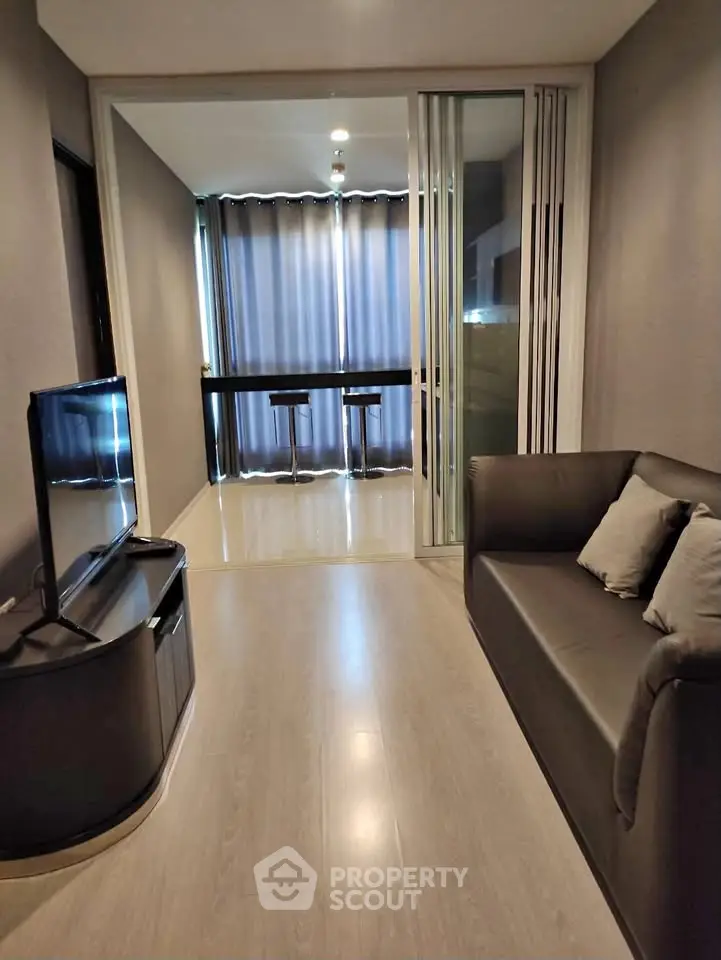Modern living room with sleek furniture and floor-to-ceiling windows for natural light.