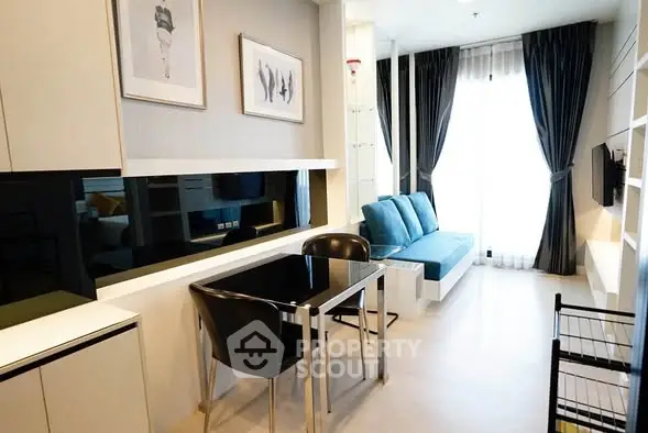 Modern living room with sleek furniture and large window for natural light.