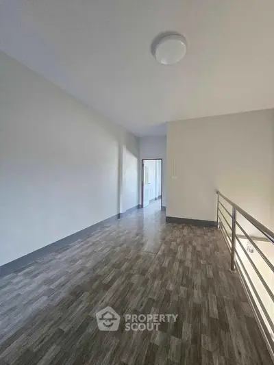 Spacious modern interior with sleek flooring and natural light, perfect for versatile living space.