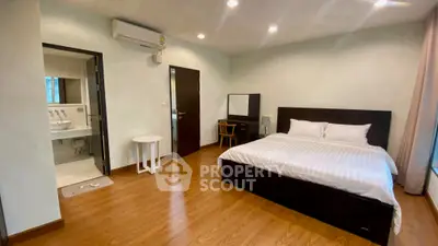 Spacious bedroom with ensuite bathroom and modern furnishings