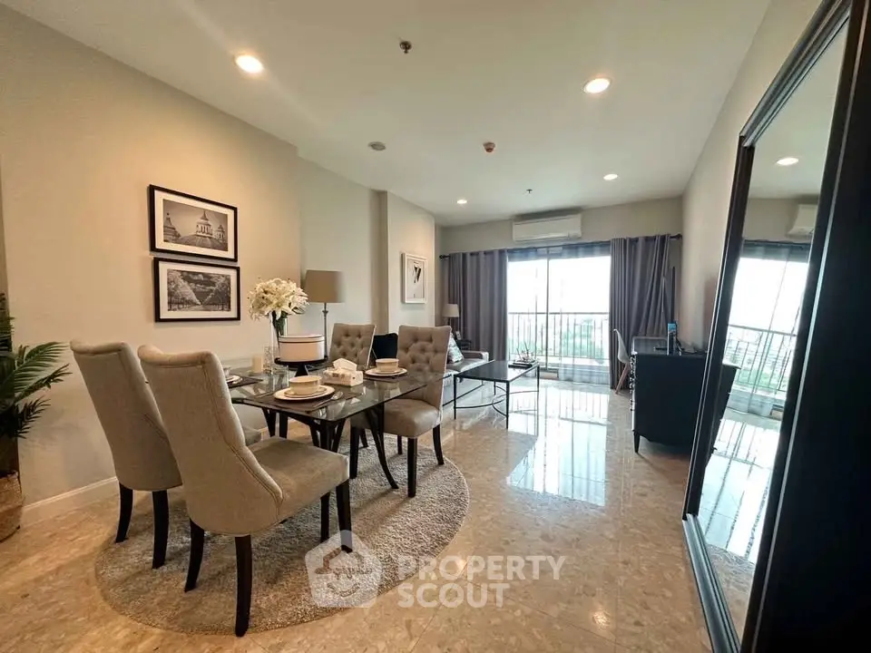Spacious modern living room with elegant dining area and large windows offering natural light.