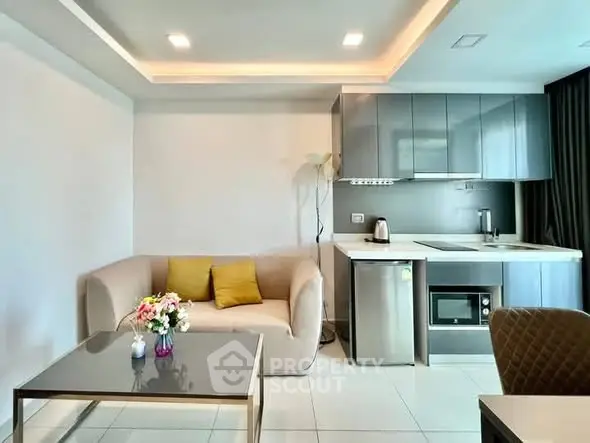 Modern living room with sleek kitchen and cozy seating area