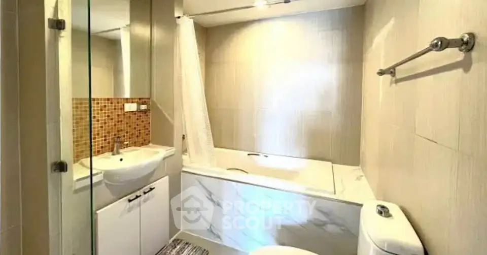 Modern bathroom with elegant tile design and bathtub in a stylish apartment.