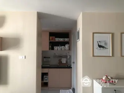 Cozy kitchen nook with modern cabinetry and stylish decor in a compact apartment.