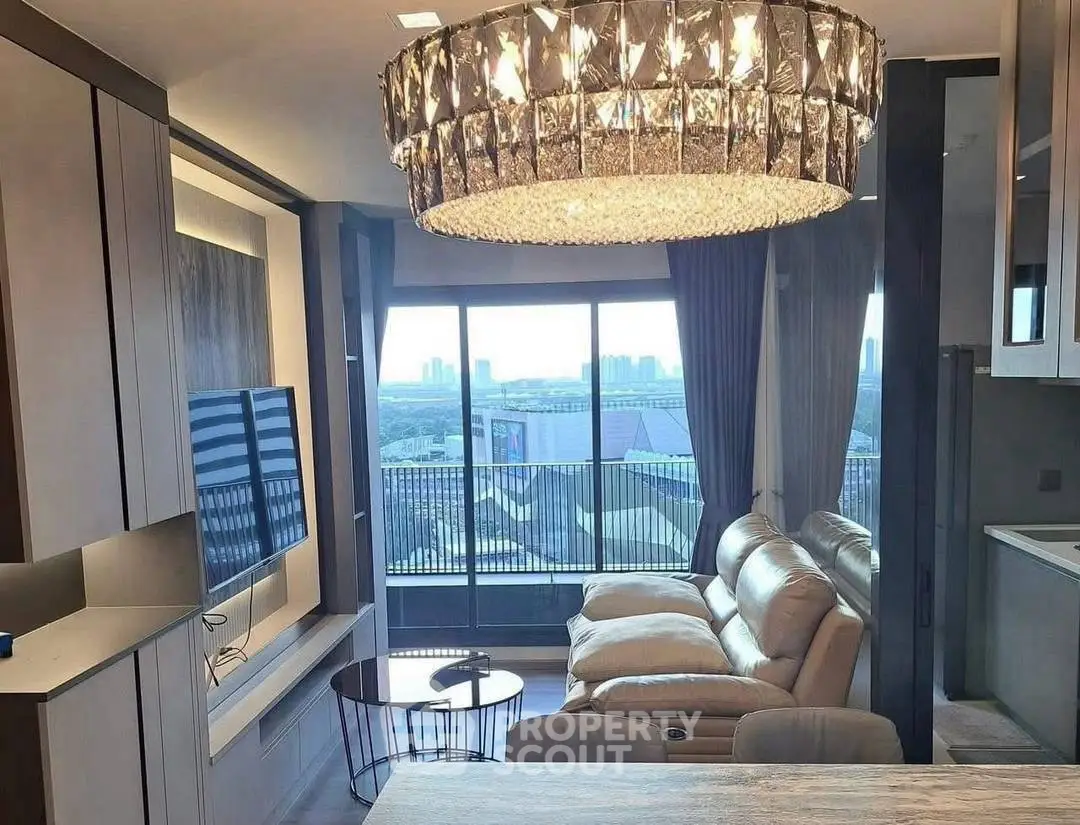 Luxurious living room with stunning chandelier and city view, perfect for modern urban living.