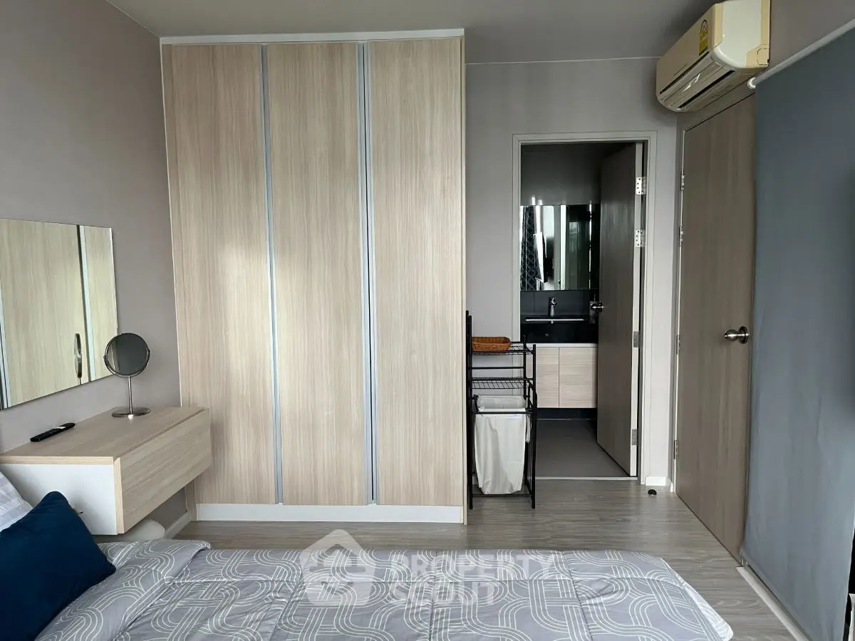 Modern bedroom with ensuite bathroom and sleek wooden wardrobe