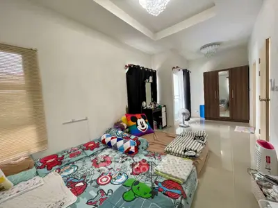 Spacious bedroom with modern decor and ample natural light
