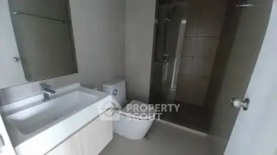 Modern bathroom with sleek fixtures and glass shower enclosure