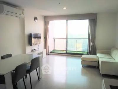 Spacious living room with modern furniture and large window offering a stunning view.