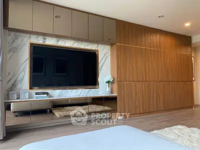 Luxurious modern living room with sleek wood paneling and large TV