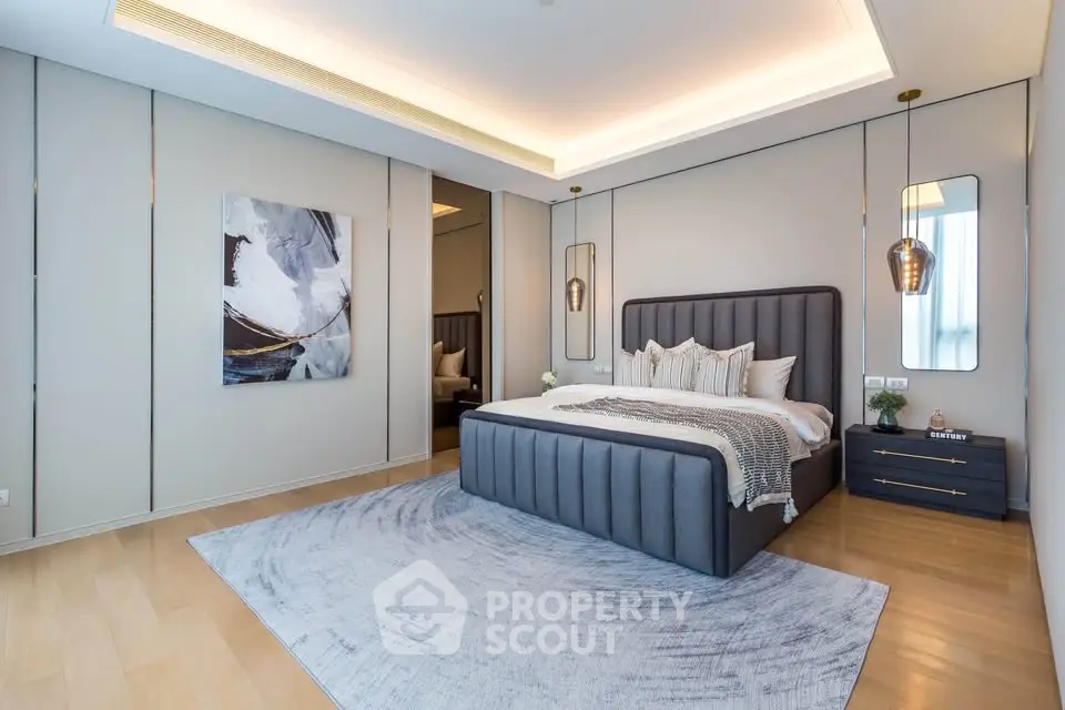 Luxurious modern bedroom with elegant decor and stylish lighting in a spacious apartment.