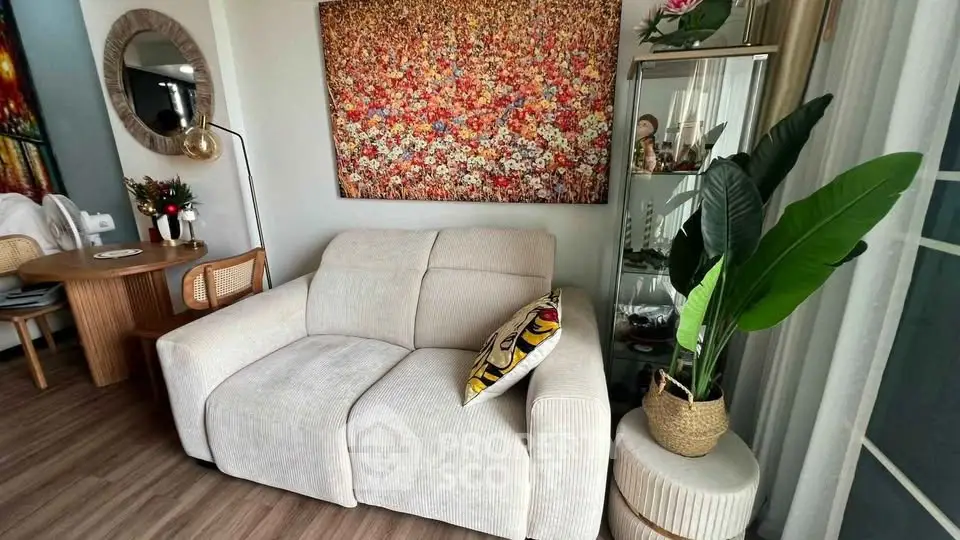 Chic living room with cozy sofa, vibrant artwork, and elegant decor in modern apartment.