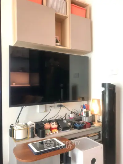 Modern living room with wall-mounted TV and stylish shelving unit