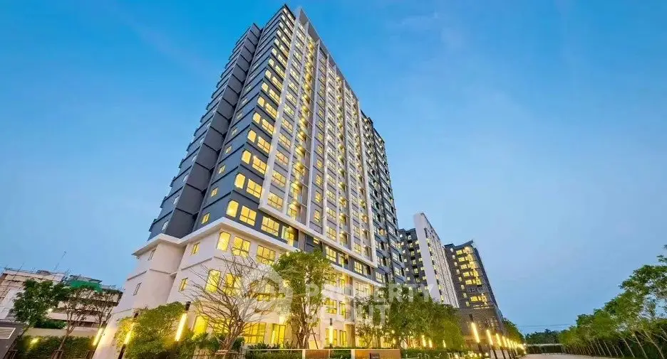 Stunning high-rise building with modern architecture and lush surroundings, perfect for urban living.