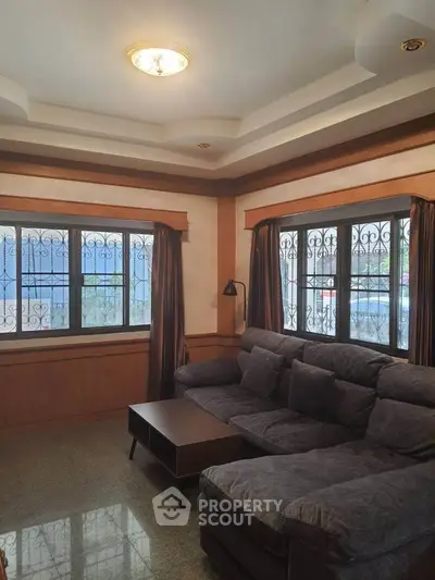 Cozy living room with plush sectional sofa and elegant ceiling design