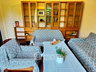 Cozy living room with wooden furniture and decorative plants