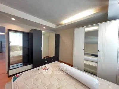 Spacious bedroom with modern wardrobe and cozy lighting