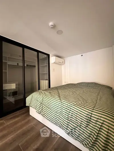 Modern bedroom with sleek design and ample storage in a stylish apartment.
