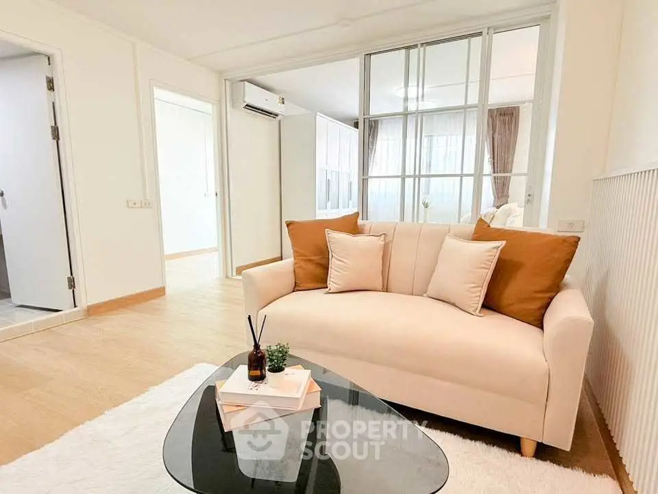 Stylish living room with cozy sofa and modern decor in bright apartment.