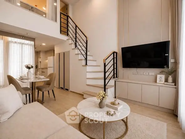 Modern living room with elegant staircase and open dining area, featuring stylish decor and natural light.
