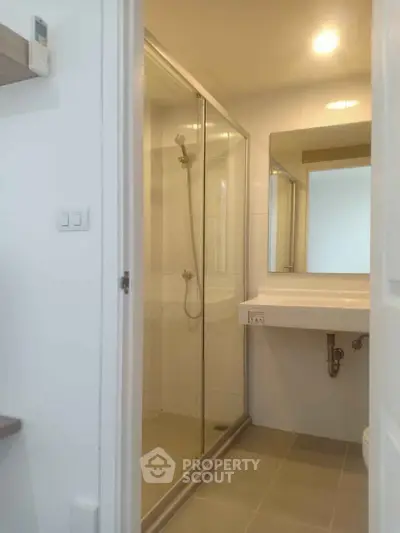 Modern bathroom with glass shower enclosure and sleek vanity