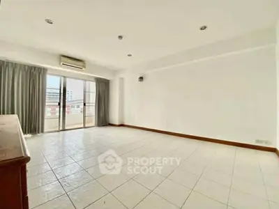 Spacious empty living room with large windows and city view, ready for customization.
