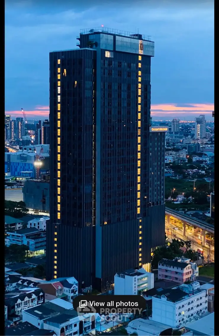 Stunning high-rise building with panoramic city views at dusk, perfect for urban living.