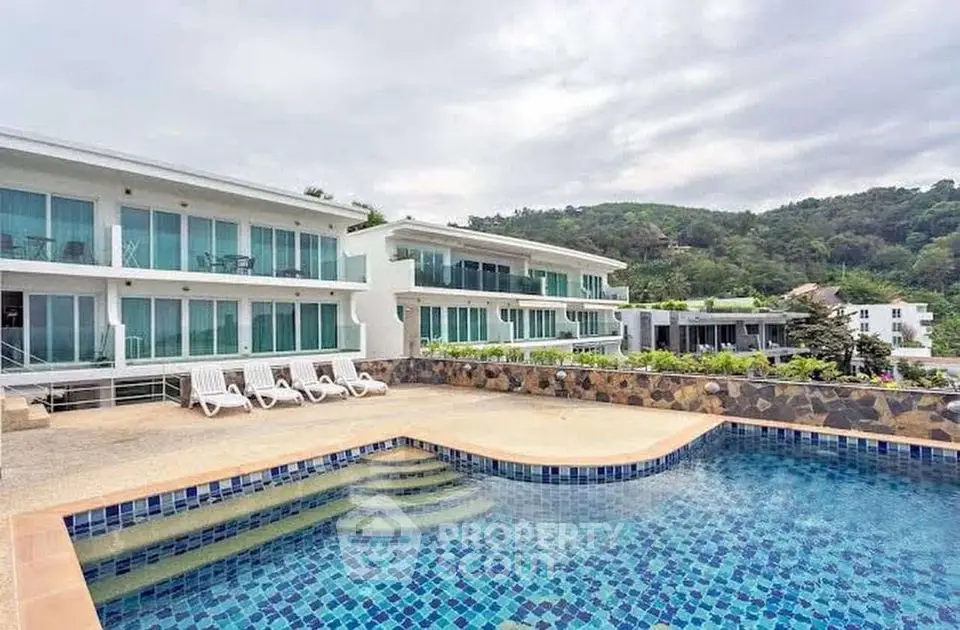 Luxurious modern apartment complex with stunning pool and scenic mountain views