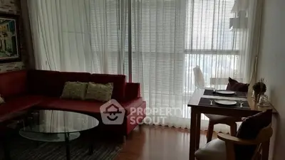 Cozy living room with red sectional sofa and dining table by large windows