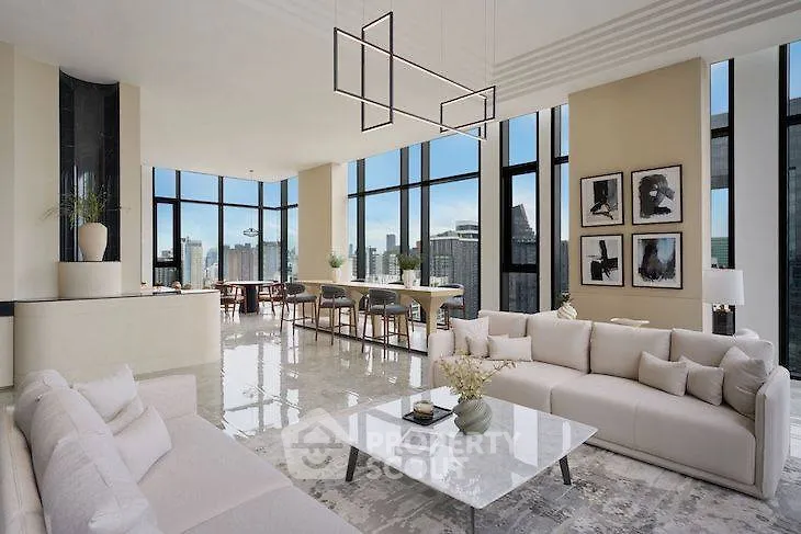 Luxurious modern living room with panoramic city views and elegant decor.