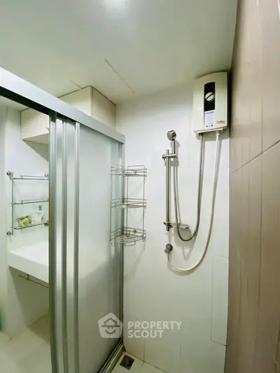 Modern bathroom with sleek shower and water heater, ideal for urban living.