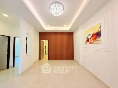 Spacious modern living room with elegant lighting and stylish wall art